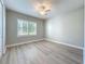 Bright bedroom featuring wood-look flooring, a ceiling fan and natural light from the window at 7810 34Th W Ave # 103, Bradenton, FL 34209