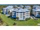 A luxury condominium boasts a manicured lawn, lush landscaping and a view of the community pond at 7810 34Th W Ave # 103, Bradenton, FL 34209