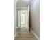 Hallway showcases a stylish grey paint, and hardwood floors, leading to various areas of the home at 7810 34Th W Ave # 103, Bradenton, FL 34209