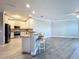 Open concept kitchen features a bar, granite countertops, stainless steel appliances, and stylish pendant lighting at 7810 34Th W Ave # 103, Bradenton, FL 34209
