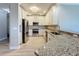 Close-up of a modern kitchen boasting stainless steel appliances, granite counters, and ample cabinet space at 7810 34Th W Ave # 103, Bradenton, FL 34209