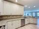 Beautiful kitchen with stainless steel dishwasher and granite countertops connected to the living area at 7810 34Th W Ave # 103, Bradenton, FL 34209