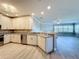 Bright, open kitchen with granite counters, stainless appliances, and hardwood floors seamlessly flowing to the living area at 7810 34Th W Ave # 103, Bradenton, FL 34209