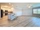 Open floor plan showing living room and kitchen with light wood floors and bright natural light at 7810 34Th W Ave # 103, Bradenton, FL 34209