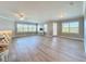 Spacious living room featuring light wood floors, ceiling fan, and multiple windows with plantation shutters at 7810 34Th W Ave # 103, Bradenton, FL 34209