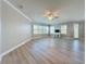 Bright living room with light wood floors, white trim, ceiling fan and windows with plantation shutters at 7810 34Th W Ave # 103, Bradenton, FL 34209