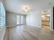 Bright living room with light wood floors, windows with plantation shutters and entrance to en-suite bathroom at 7810 34Th W Ave # 103, Bradenton, FL 34209