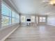 Large living room with light wood floors and lots of windows with plantation shutters for ample natural light at 7810 34Th W Ave # 103, Bradenton, FL 34209