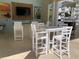 Community outdoor kitchen with seating, dining, a grill, and a mounted flatscreen television at 7810 34Th W Ave # 103, Bradenton, FL 34209