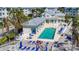 Aerial shot showcasing a bright blue community pool with ample lounge chairs and tropical landscaping at 7810 34Th W Ave # 103, Bradenton, FL 34209