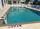 Community pool with crystal clear water, measuring 5ft 6in deep with chairs for relaxing at 7810 34Th W Ave # 103, Bradenton, FL 34209