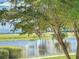 Scenic water view featuring mature trees and community landscaping at 7810 34Th W Ave # 103, Bradenton, FL 34209
