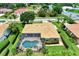 Aerial view of a home with a screened-in pool and spa surrounded by lush landscaping at 8449 Lone Eagle Way, Sarasota, FL 34241