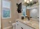 Comfortable bathroom offering a stylish vanity with marble countertops, decorative fixtures, and a step-in shower at 8449 Lone Eagle Way, Sarasota, FL 34241