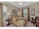 Inviting bedroom with a ceiling fan, side table, lamps, and warm, neutral tones at 8449 Lone Eagle Way, Sarasota, FL 34241