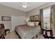 Relaxing bedroom with a ceiling fan, side table, lamps, and plush bedding at 8449 Lone Eagle Way, Sarasota, FL 34241