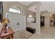 Bright foyer with double doors, arched transom window, and tiled floors at 8449 Lone Eagle Way, Sarasota, FL 34241