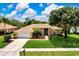 Beautiful home with lush lawn, mature trees, and a well-maintained exterior at 8449 Lone Eagle Way, Sarasota, FL 34241