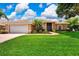 Charming home featuring a well-maintained lawn and lush tropical landscaping at 8449 Lone Eagle Way, Sarasota, FL 34241