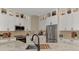 A bright kitchen with white cabinets and stainless steel appliances, including a modern sink at 8449 Lone Eagle Way, Sarasota, FL 34241