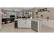Open kitchen layout with an island, stainless steel appliances, and seamless access to the living area at 8449 Lone Eagle Way, Sarasota, FL 34241