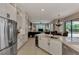 Bright, open kitchen with stainless steel appliances and a view into the living area and pool beyond at 8449 Lone Eagle Way, Sarasota, FL 34241