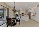 Expansive view of the kitchen and dining room featuring granite countertops, stainless appliances, and a stylish chandelier at 8449 Lone Eagle Way, Sarasota, FL 34241