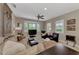 Comfortable living room featuring neutral tones, bay windows with plantation shutters and ample seating at 8449 Lone Eagle Way, Sarasota, FL 34241