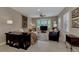 Comfortable living room with neutral tones, large windows, and stylish furnishings at 8449 Lone Eagle Way, Sarasota, FL 34241