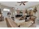 Inviting living room featuring plush leather seating, decorative accents, and an open entryway with natural light at 8449 Lone Eagle Way, Sarasota, FL 34241