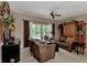 A cozy living area with leather seating, a view of the pool, and rich wooden accents at 8449 Lone Eagle Way, Sarasota, FL 34241