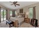 Calm main bedroom with a luxurious bed, dual nightstands, and views of the pool at 8449 Lone Eagle Way, Sarasota, FL 34241