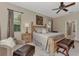 Serene main bedroom with a plush bed, soft lighting, and comfortable seating area at 8449 Lone Eagle Way, Sarasota, FL 34241