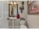 Elegant powder room featuring decorative mirror, stylish fixtures, and a classic pedestal sink at 8449 Lone Eagle Way, Sarasota, FL 34241