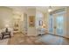 Inviting foyer with tile flooring, a decorative rug, and a view of the entry doors at 8504 Woodbriar Dr, Sarasota, FL 34238