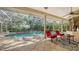 Covered patio overlooking a stunning pool and lush greenery, ideal for outdoor enjoyment at 8504 Woodbriar Dr, Sarasota, FL 34238