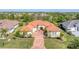 A sprawling home with tile roof sits on a manicured lot in an upscale neighborhood at 909 143Rd Ne St, Bradenton, FL 34212