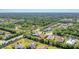 Aerial view of the community featuring well-maintained homes, lush trees, and a serene landscape at 909 143Rd Ne St, Bradenton, FL 34212