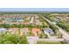 Beautiful aerial view of a neighborhood featuring well-maintained homes, lush landscaping and scenic pond views at 909 143Rd Ne St, Bradenton, FL 34212