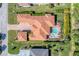 Birds eye view of a luxury home with a red tile roof, pool and lush landscaping at 909 143Rd Ne St, Bradenton, FL 34212