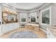 Bright bathroom featuring double vanity, soaking tub with tile surround, and large windows for natural light at 909 143Rd Ne St, Bradenton, FL 34212
