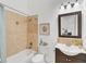 Well-lit bathroom featuring neutral tile, framed art, and a modern vanity with a dark wood cabinet at 909 143Rd Ne St, Bradenton, FL 34212
