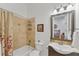 Bathroom featuring a vanity with a unique sink, framed mirror, and a shower-tub combination at 909 143Rd Ne St, Bradenton, FL 34212