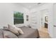 Bedroom with cozy bed, ensuite bathroom, and natural light from window at 909 143Rd Ne St, Bradenton, FL 34212
