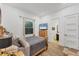 Cozy bedroom with wooden bed frame, ensuite bathroom, and natural light from a window at 909 143Rd Ne St, Bradenton, FL 34212