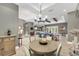Open concept dining area with modern chandelier and views into living spaces at 909 143Rd Ne St, Bradenton, FL 34212