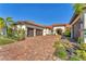 Elegant home with brick paver driveway, three-car garage and well-manicured landscaping at 909 143Rd Ne St, Bradenton, FL 34212