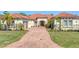 Stunning home with red tile roof, paver driveway and lush tropical landscaping at 909 143Rd Ne St, Bradenton, FL 34212