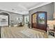 Elegant foyer with wood floors, arched doorway and dining area with chandelier at 909 143Rd Ne St, Bradenton, FL 34212