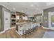 Open kitchen features a large island, granite countertops, stainless steel appliances, and hardwood floors at 909 143Rd Ne St, Bradenton, FL 34212